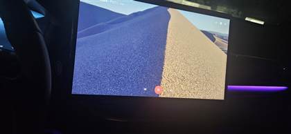 MultiWave's full-screen player on a car dashboard, viewed from inside the car