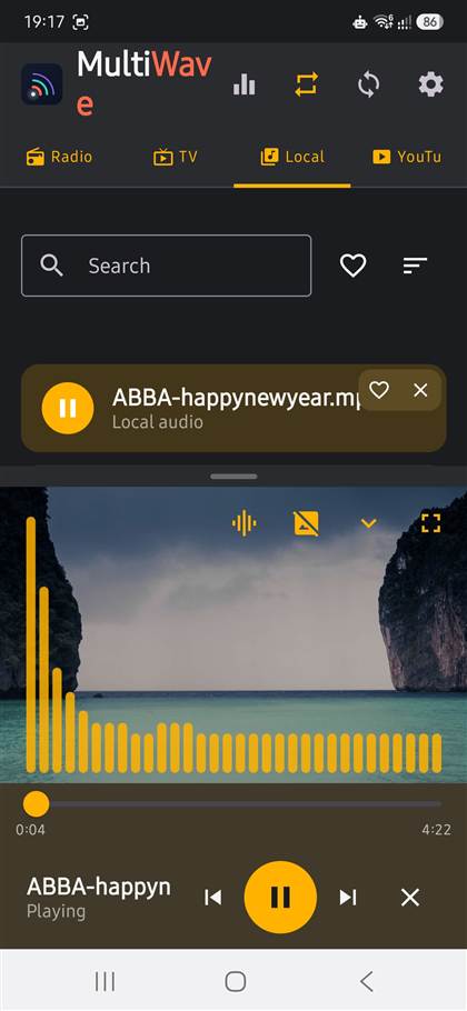 MultiWave Local tab playing an ABBA track with animated equalizer over a beach photo